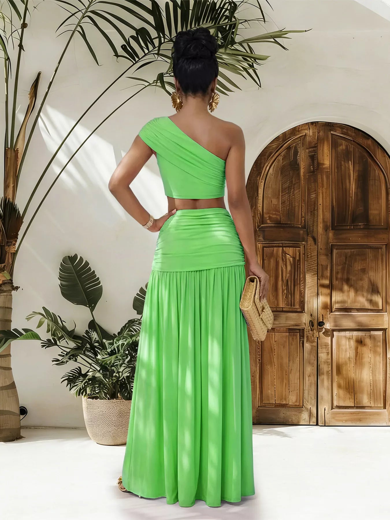 Trendsi one-shoulder top and ruched maxi skirt set displayed on a model, featuring a stylish, coordinated fashion look.