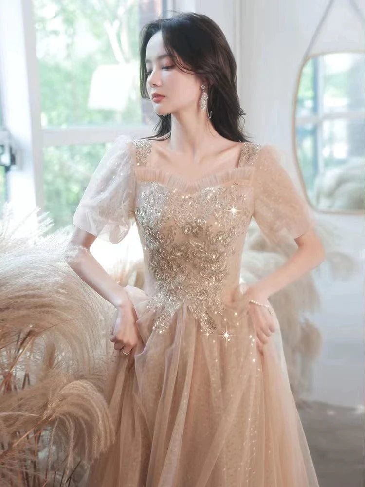 Champagne-colored embroidered evening gown by Showlu Fashion, mid-length dress with elegant vocal music-inspired design.