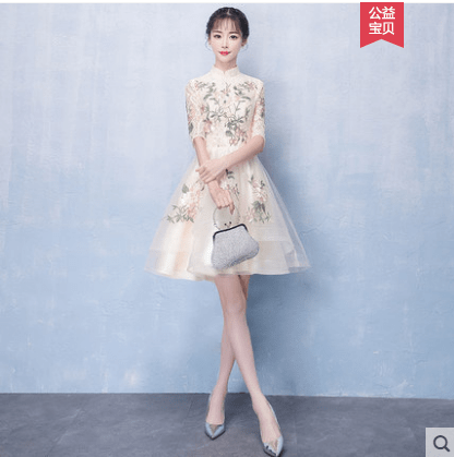 Champagne embroidered evening gown by Showlu Fashion with elegant mid-length design and musical note embellishments.