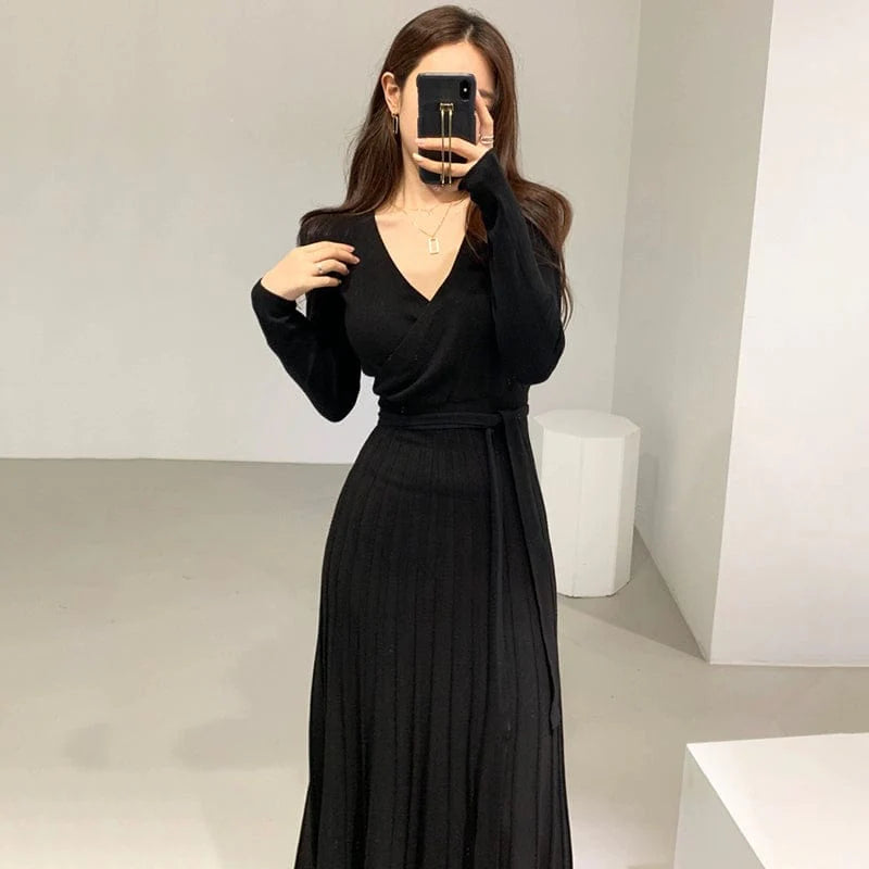 Chic SHOWLU FASHION slimming pleated knit dress with V-neck, long sleeves, and cross lace-up detail, perfect for stylish occasions.