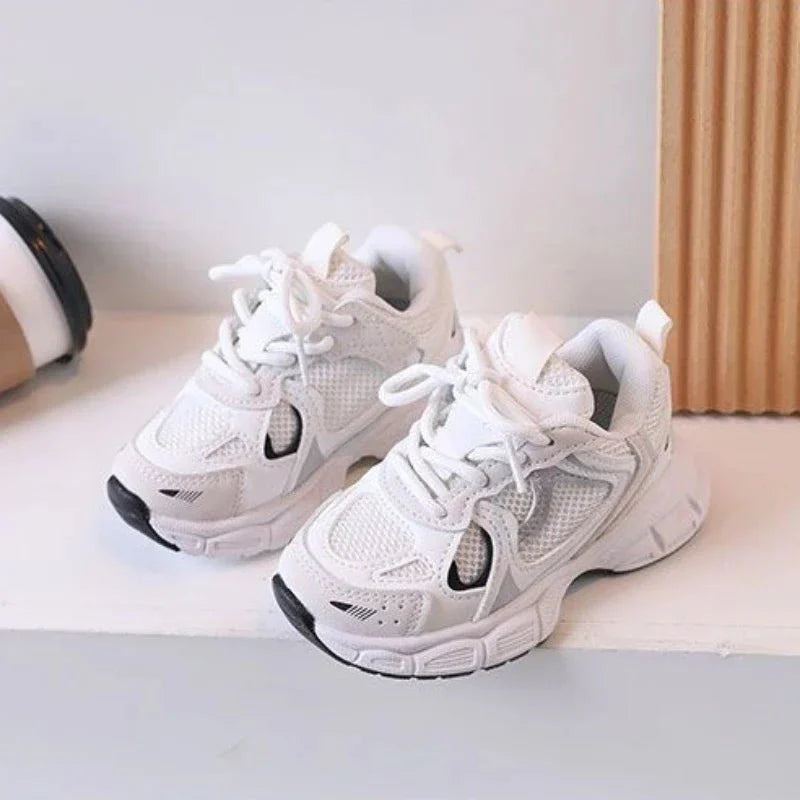 Children's Showlu Kids Tennis Shoes in white, breathable sneakers with non-slip soles for boys and girls, perfect for active play.