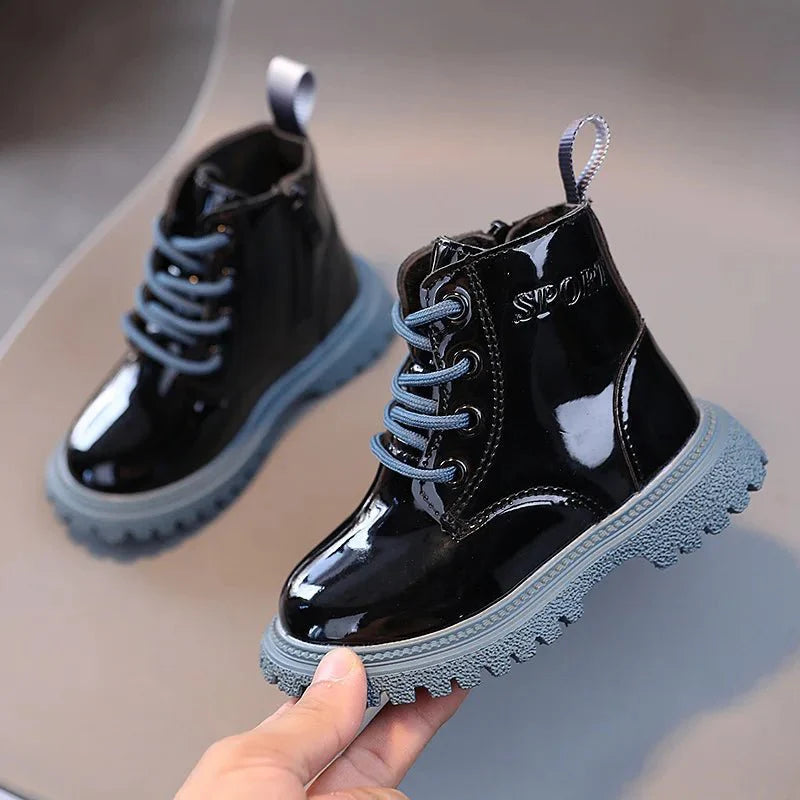 Unisex shiny PU leather ankle boots for kids, showing solid color design with a sleek, stylish look for boys and girls.