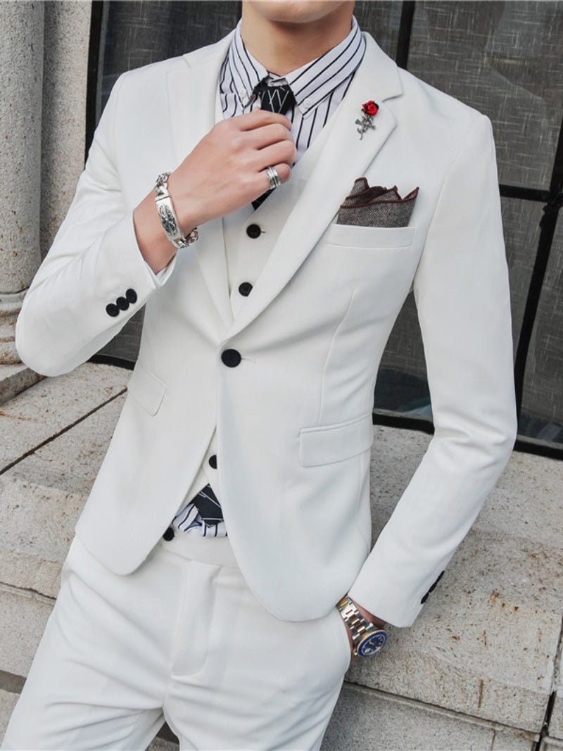 Slim-fit men's three-piece wedding suit in a casual Korean style, featuring a jacket, vest, and trousers, worn by a handsome groom.