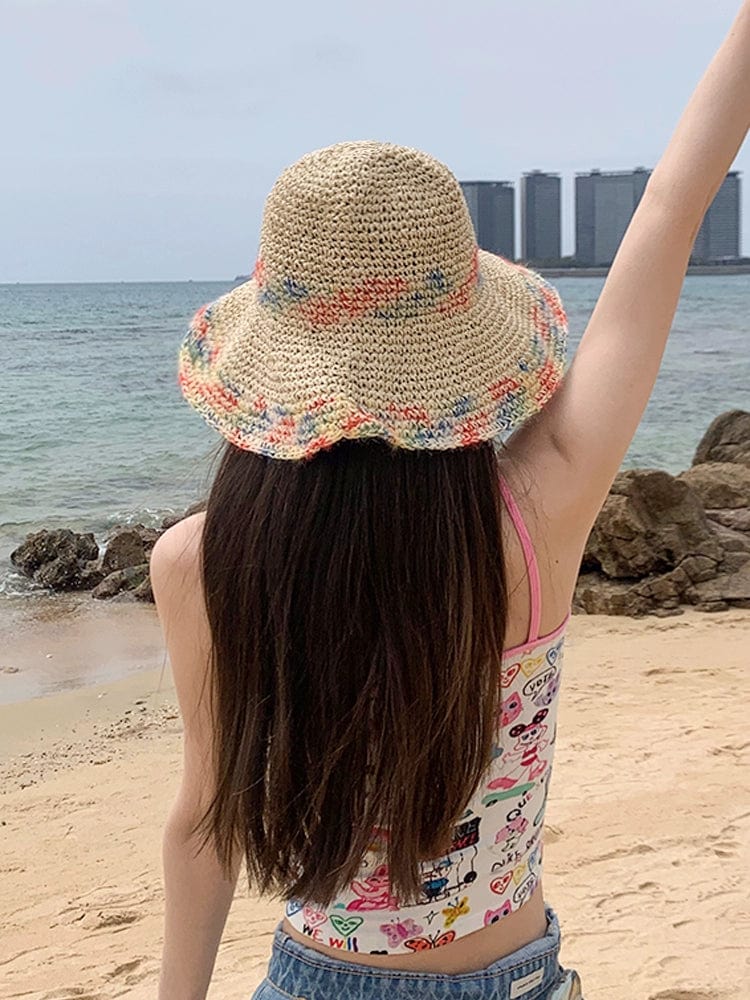 Woven straw women's summer seaside sun hat with a wide brim, stylish and perfect for sunny beach or outdoor vacation.
