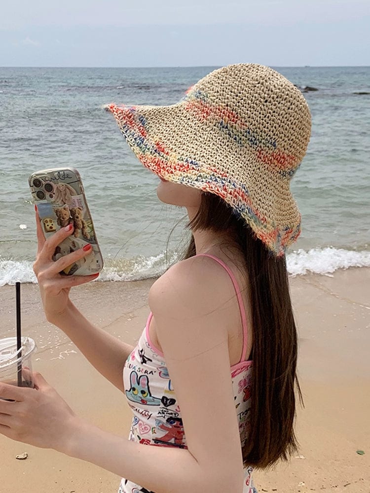 Woven straw women's summer seaside sun hat with a wide brim and hollow design, perfect for beach vacation and outdoor sun protection.