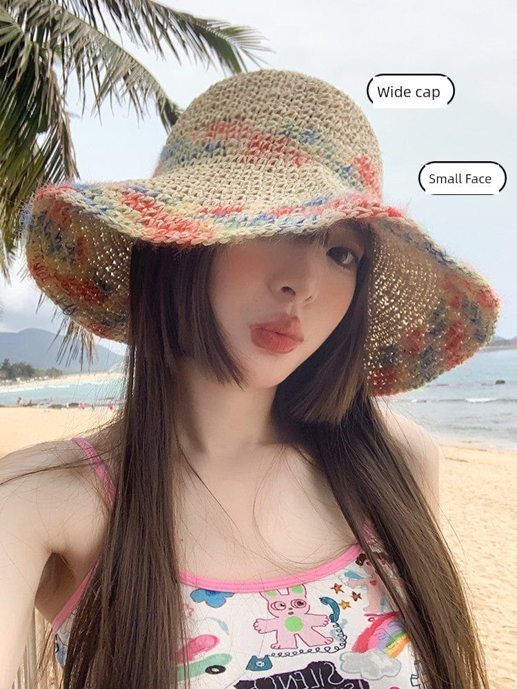 Woven straw women's summer seaside sun hat with a wide brim and hollowed design, perfect for beach and vacation outings.