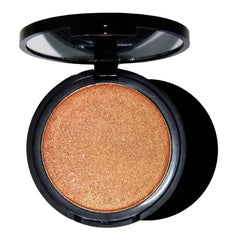 An open black compact containing a shimmering gold pressed powder highlighter.