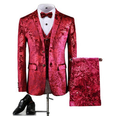 A red three-piece suit with a floral bronzing print, including a blazer, vest, and trousers.