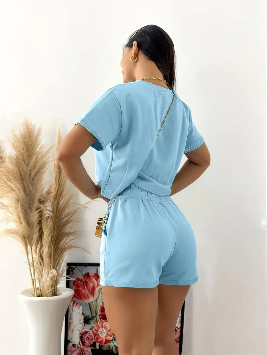 Showlu Women's two-piece summer suit with crew neck short sleeve top and matching shorts, casual and comfortable for warm weather.