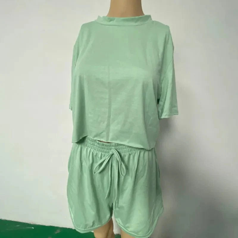 Showlu Women's two-piece summer suit with crew neck short sleeve top and matching shorts for casual warm-weather wear.
