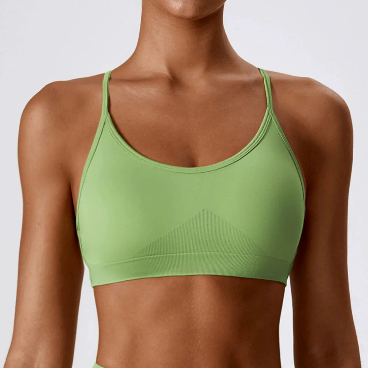 Showlu Seamless Cross Back Yoga Bra made of quick-dry nylon with tight braces and a supportive, stylish back design.