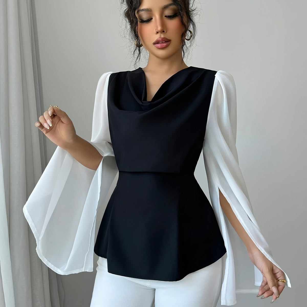 SHOWLU Women's black and white pleated asymmetrical long sleeve blouse with stylish design and flowing fabric.