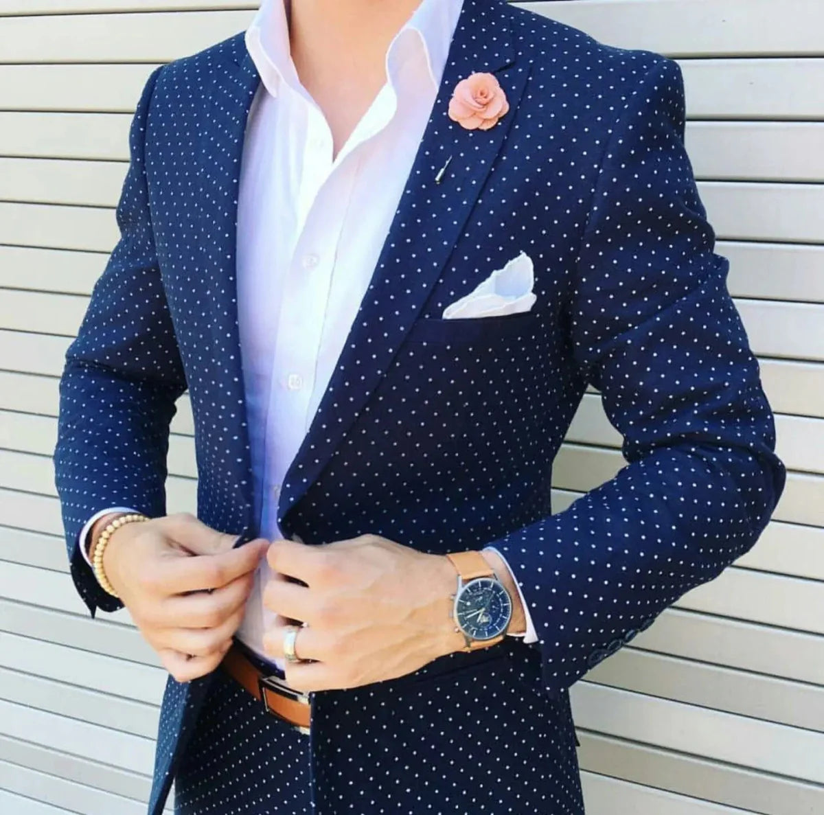 Dark blue dot slim fit men's suit with peaked lapel, 2-piece tuxedo, featuring a single button jacket and matching pants.