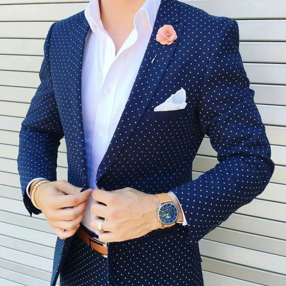 Dark blue dot slim fit men's suit with peaked lapel, one-button tuxedo jacket and matching pants, ideal for formal occasions.