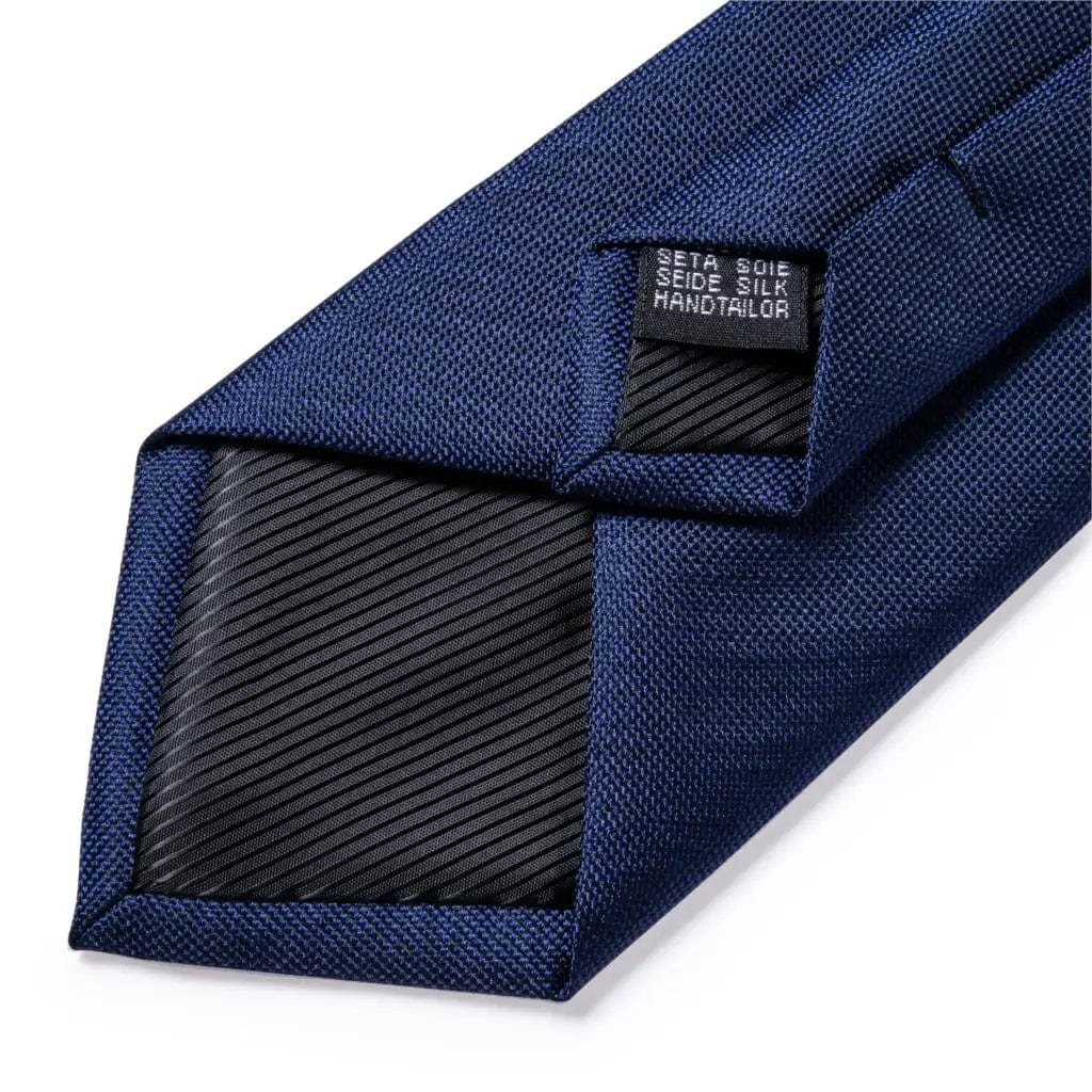 Navy blue silk tie set for men with matching cufflinks, includes a tie and pocket square, perfect for business or formal occasions.