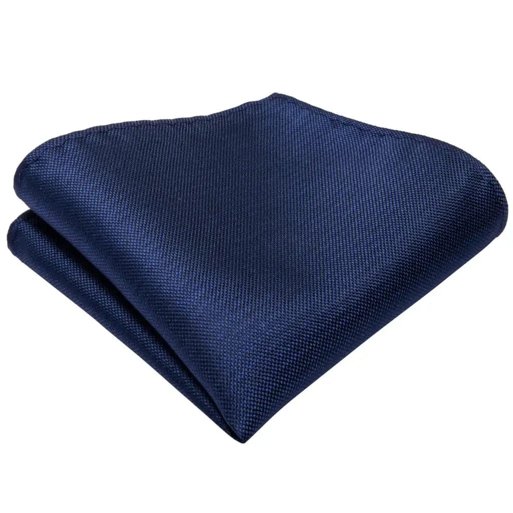 Navy blue solid silk tie set for men including necktie, cufflinks, and pocket square, perfect for business or formal occasions.