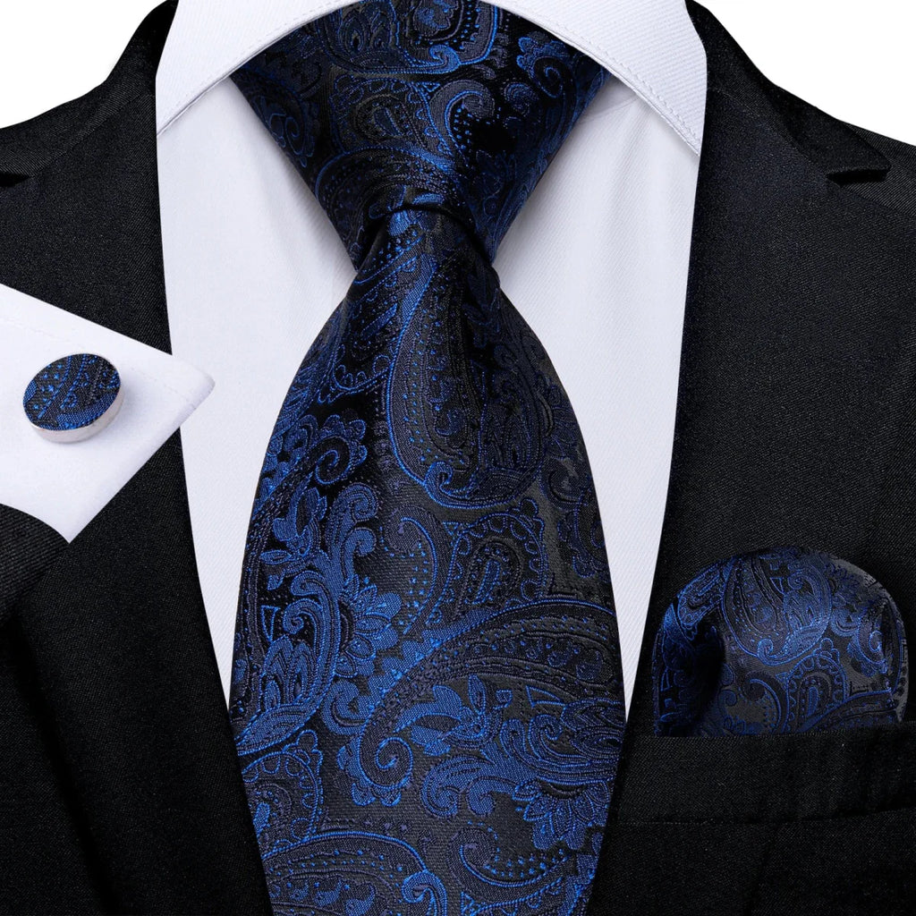 Navy blue silk tie set for men including cufflinks and matching pocket square, showcasing a sleek, solid design for formal occasions