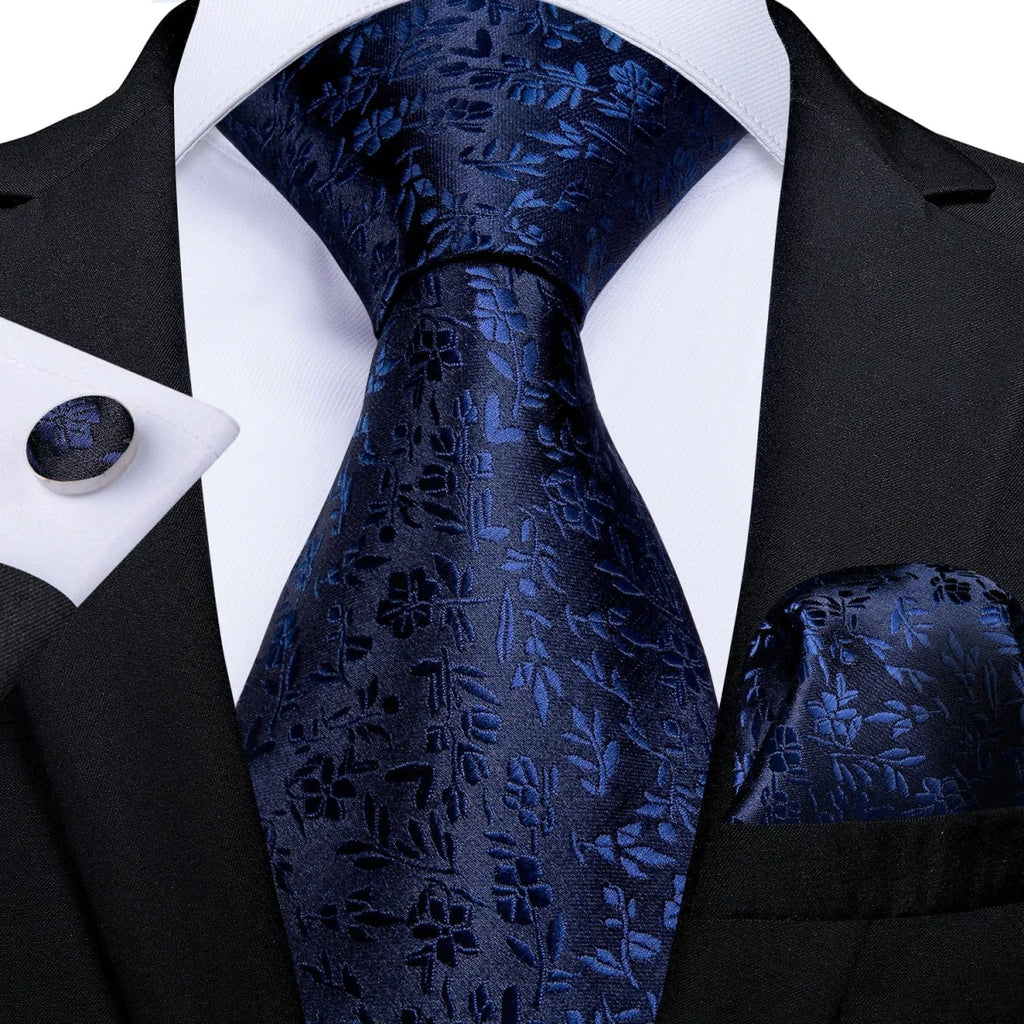 Navy blue solid silk tie set for men, including necktie, cufflinks, and pocket square, ideal for business or formal occasions.