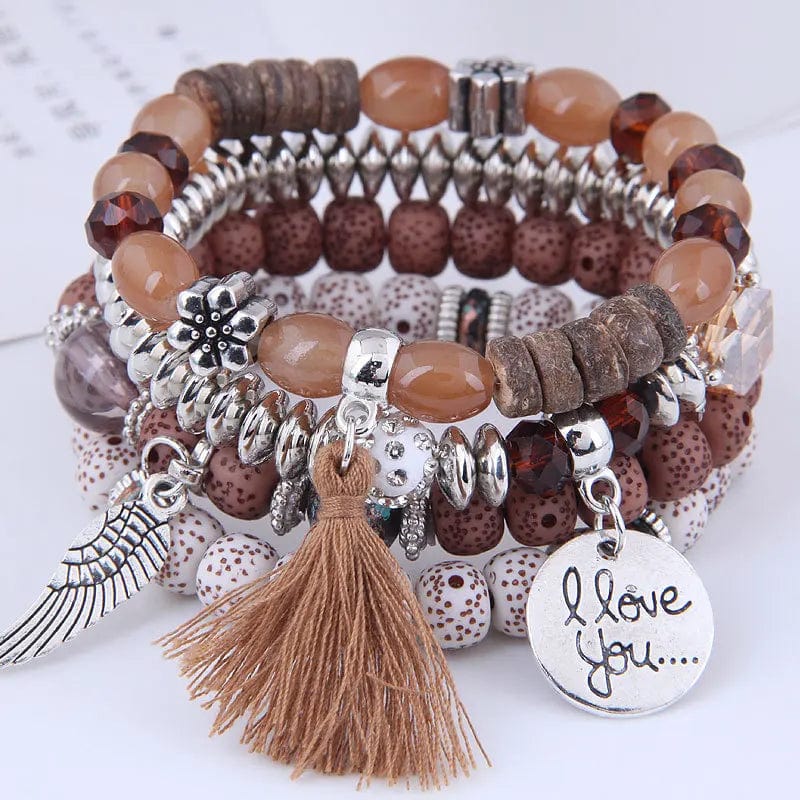 Bohemian pink crystal bead bracelet for women with elastic tassel wing and letter details, stylish accessory for women and girls.
