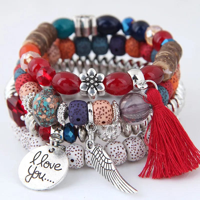 Colorful pink crystal beads bracelet with tassel and wing charms, elastic design, perfect for women and girls.