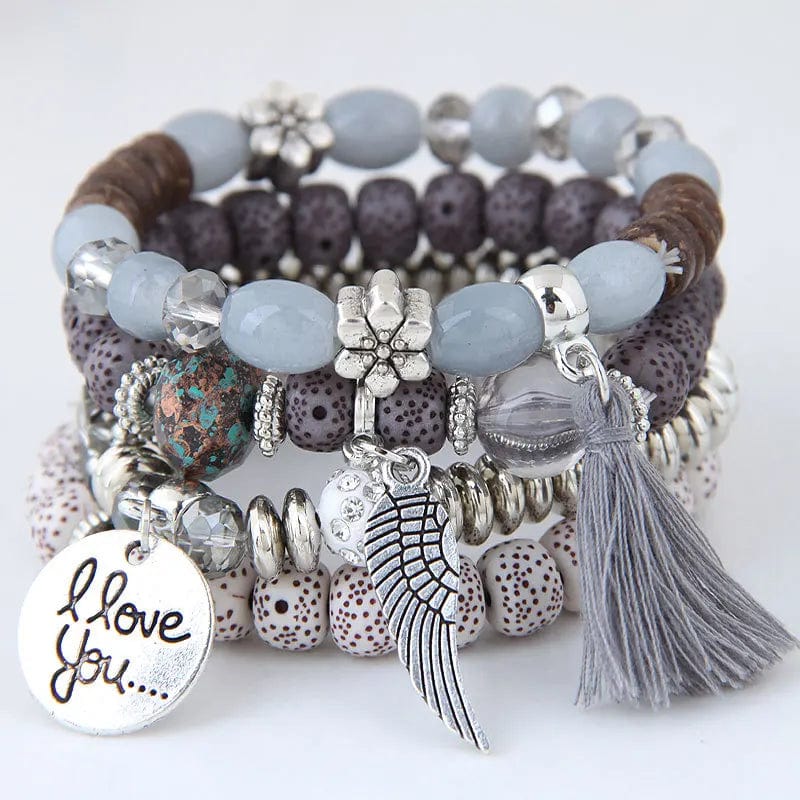 Bohemian pink crystal bead bracelet with tassel wing and elastic design, stylish accessory for women and girls.