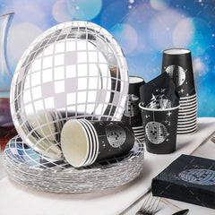 A disco ball themed party tableware set featuring black and silver plates, cups, and napkins.