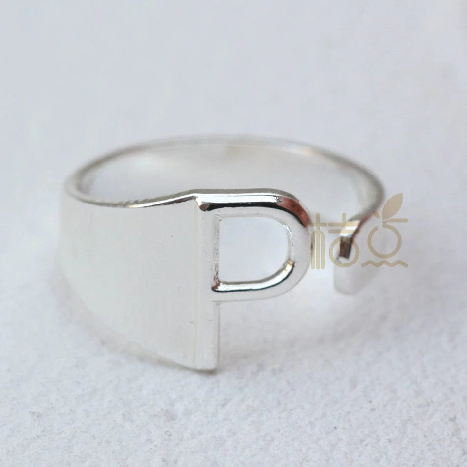 Silver plated open ring with customizable letter ornament, featuring a sleek design for stylish finger jewelry.