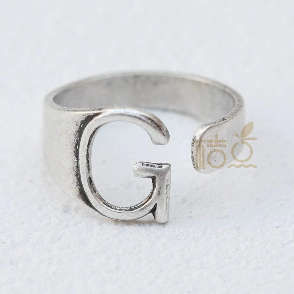 Silver plated open ring with customizable letter ornament, designed for finger wear and DIY jewelry projects.