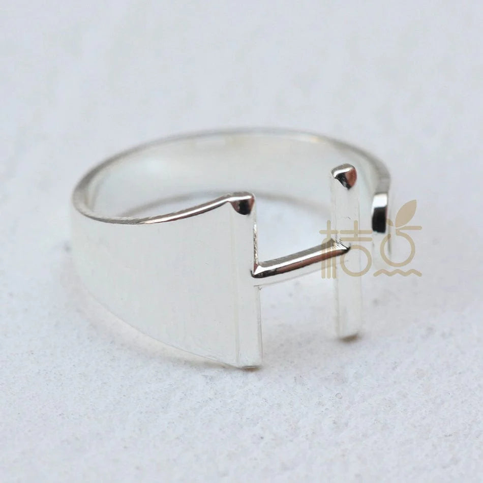 Silver plated open ring from Showlu featuring customizable letter ornaments for a stylish, personalized finger accessory.