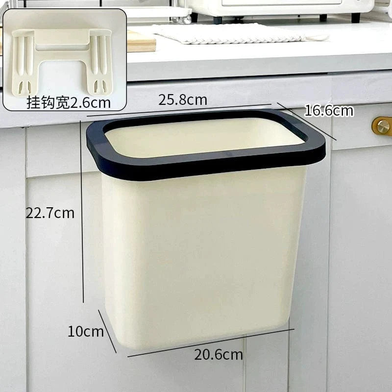 Donha wall-mounted kitchen trash can in white plastic, 4L capacity, hanging on cabinet door for easy waste disposal.