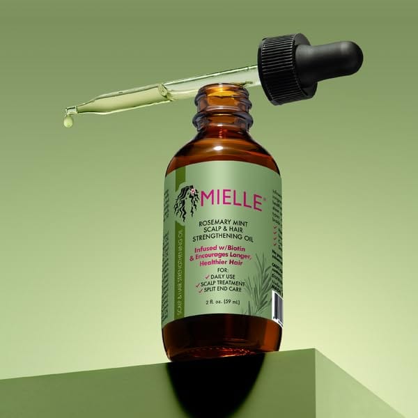 Mielle Organics Rosemary Mint Hair Strengthening Oil with Biotin in a 2oz bottle, suitable for all hair types, with rosemary and mint ingredients.