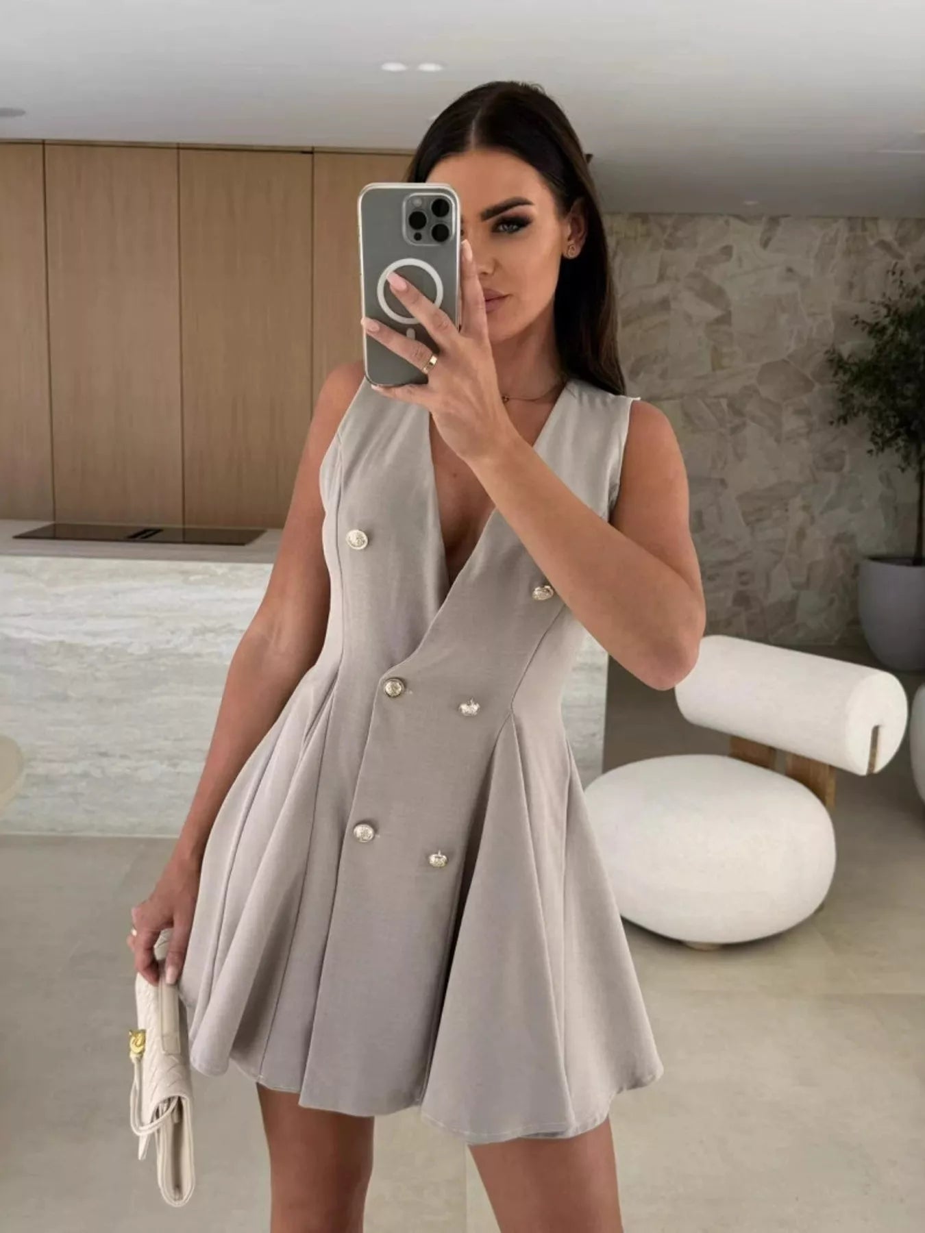 Double-breasted V-neck mini dress by Trendsi featuring a fitted silhouette and stylish button details, perfect for casual or semi-formal wear.