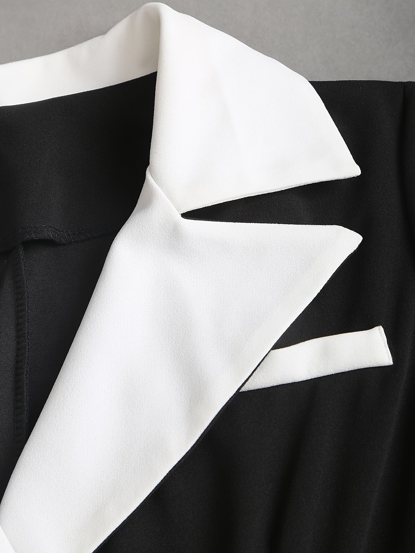V-neck two-tone slim fit dress by SHOWLU FASHION STORE featuring a belt and pockets, styled for a modern, elegant look.