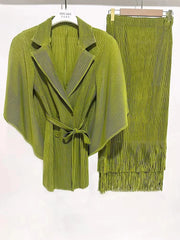A lime green pleated two-piece set featuring a batwing sleeve blazer and a tasseled A-line skirt.
