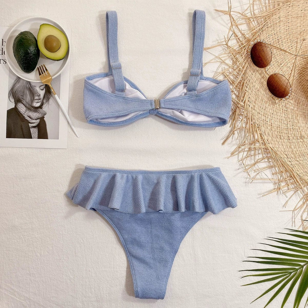 Elegant Showlu Fashion ruffled high-waist bikini two-piece swimsuit displayed on a model with a floral background.
