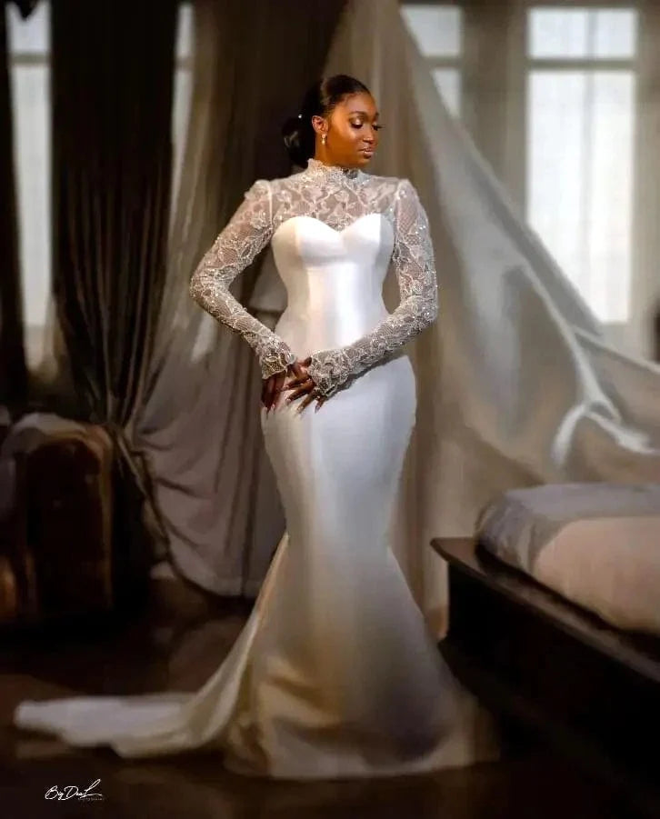 Elegant satin mermaid wedding dress with long sleeves and back buttons, fitted bridal gown perfect for a formal wedding.