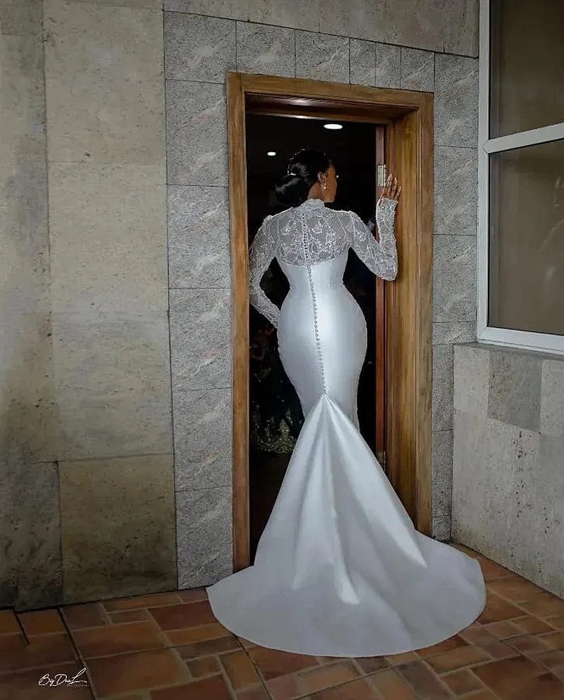 Elegant satin mermaid wedding dress with long sleeves, back buttons, fitted silhouette, perfect for bridal occasions.