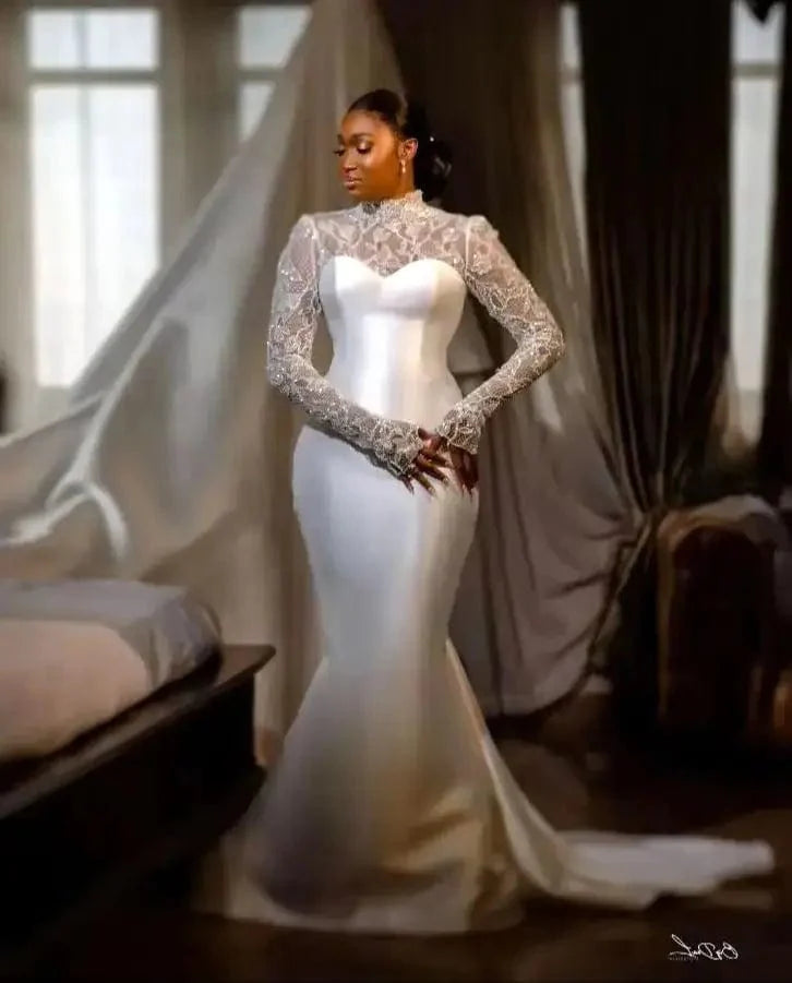 Elegant satin mermaid wedding dress with long sleeves and back buttons, featuring a fitted silhouette for bridal elegance.