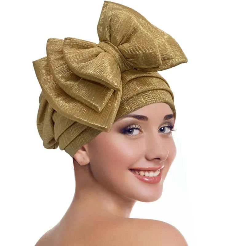 Elegant women's gold turban cap with multi-layer bowknot, African headtie, and headwrap style for stylish women.