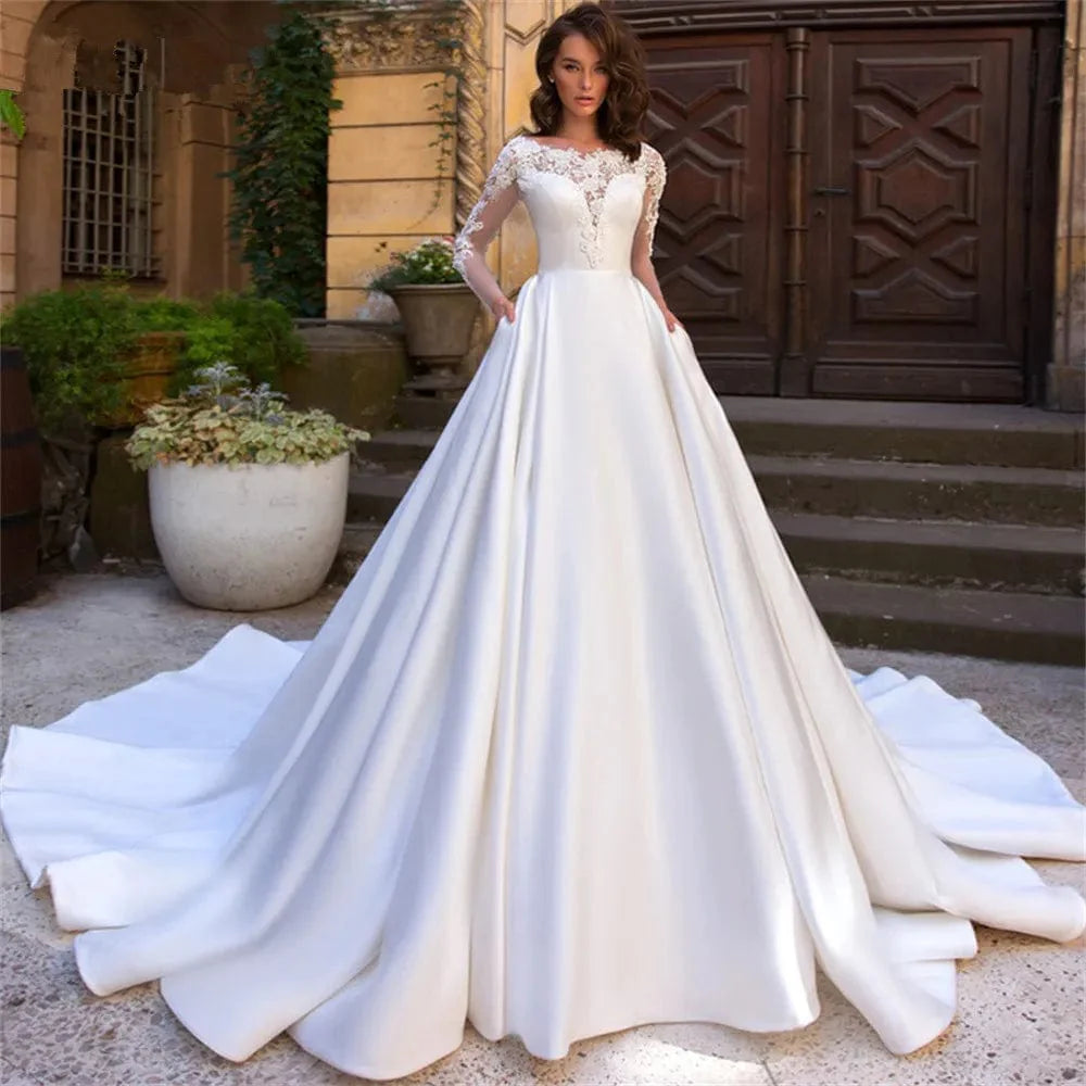 Elegant Showlu Women's lace applique A-line wedding gown with long satin sleeves, pleated skirt, perfect for bridal or formal occasions.