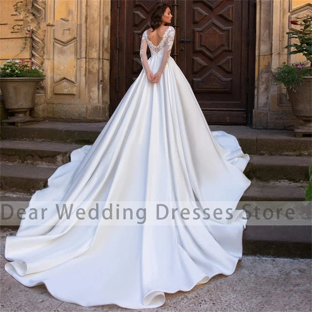 Elegant Showlu Women's lace applique A-line wedding gown with long satin sleeves, pleated design, perfect for formal and bridal occasions.