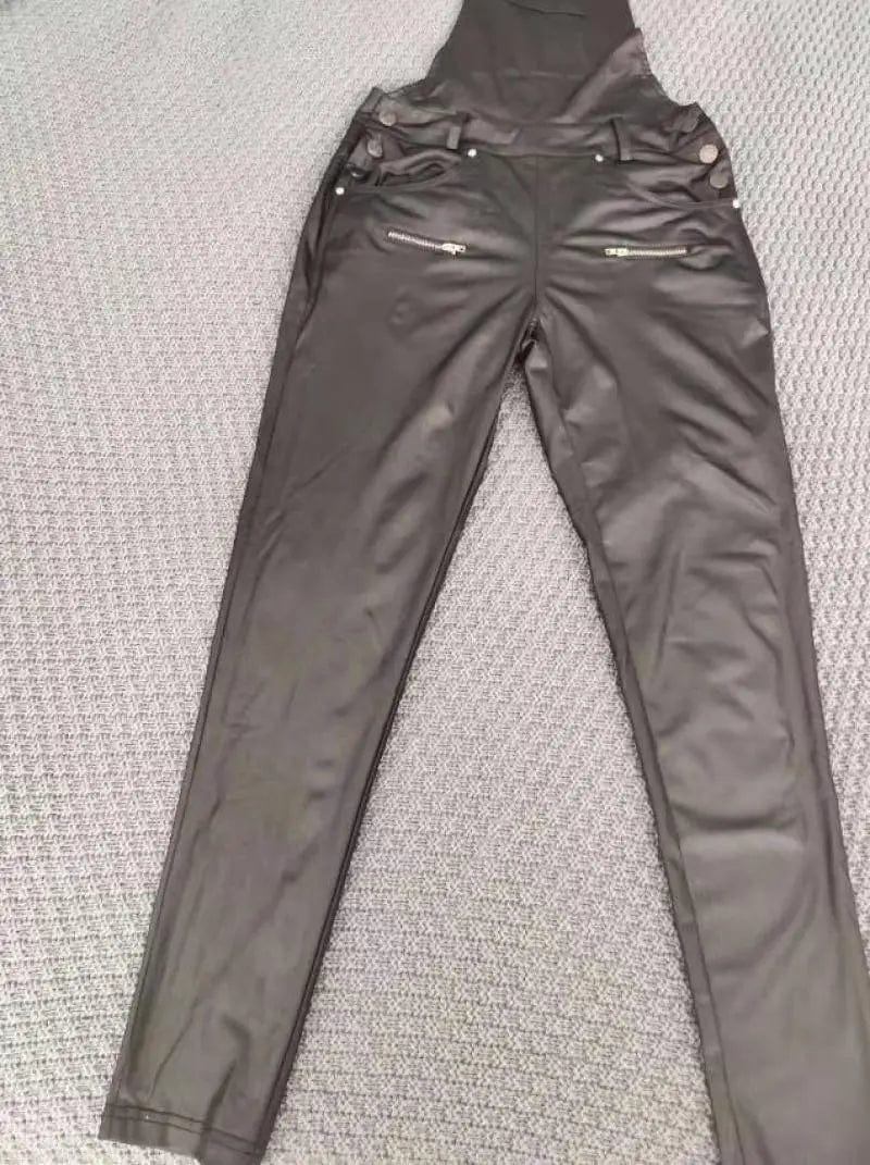 Elegant women's black PU leather square neck jumpsuit with shoulder straps, zipper, and suspender details, form-fitting and stylish.
