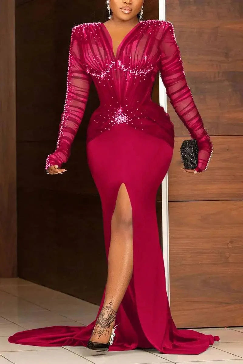 Plus size women's sequin maxi dress with V-neck, long sleeves, ruched design, rhinestone accents, pearl details, and slit train.