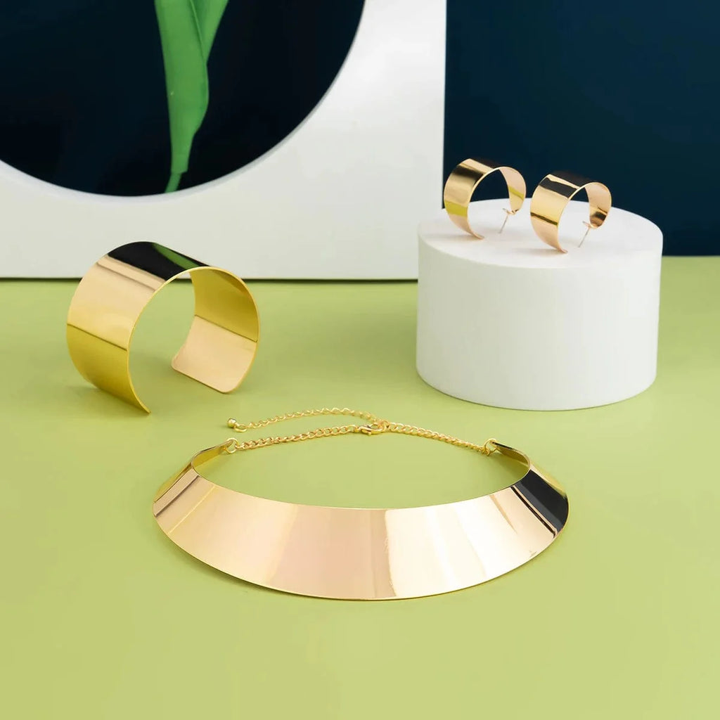 African collar jewelry set by Showlu Fashion featuring a wide smooth metal necklace and matching earrings for women.