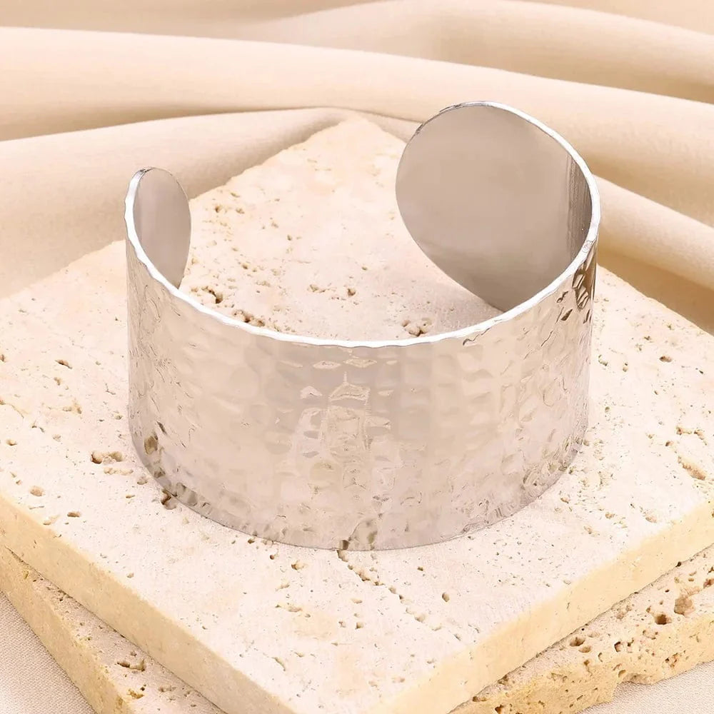Gold stainless steel cuff bracelet with bump pattern for women, featuring an open design and stylish hand ornament detail.