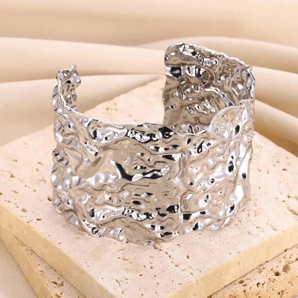 Gold stainless steel cuff bracelet with bump pattern, open design, stylish for women, elegant hand jewelry accessory.
