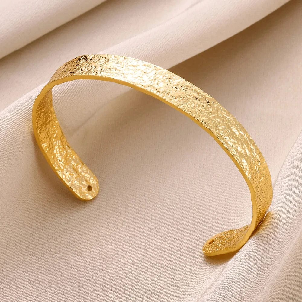 Gold stainless steel bump pattern cuff bracelet for women, open design with elegant bump details, stylish hand accessory.