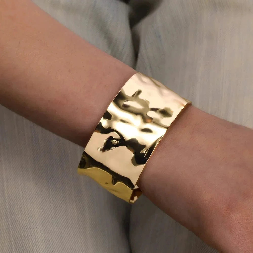 Gold stainless steel cuff bracelet with bump pattern, open design for women, stylish hand jewelry or gift accessory.