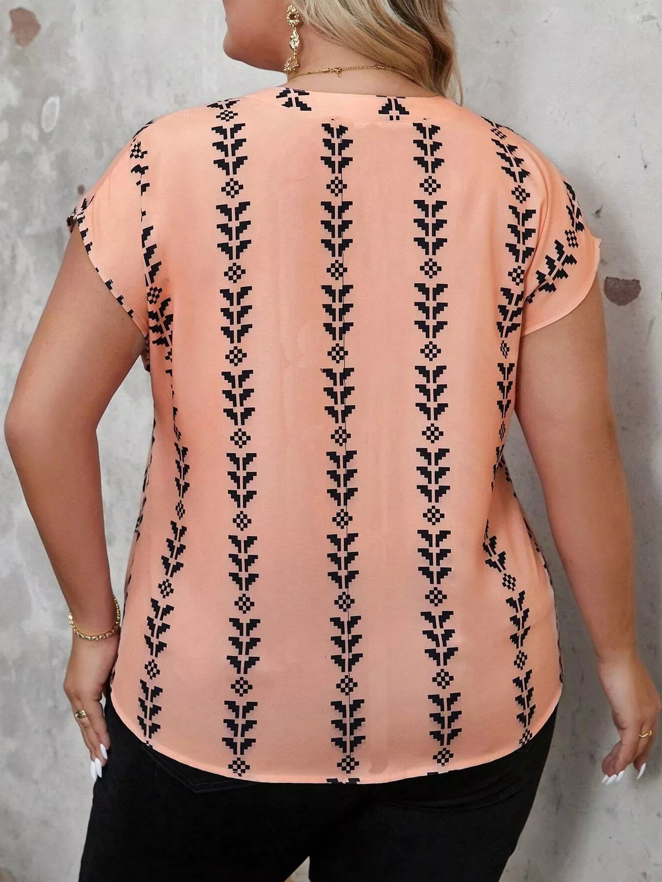 Plus size notched short sleeve blouse from Trendsi, featuring a stylish neckline and comfortable fit, shown on a model.