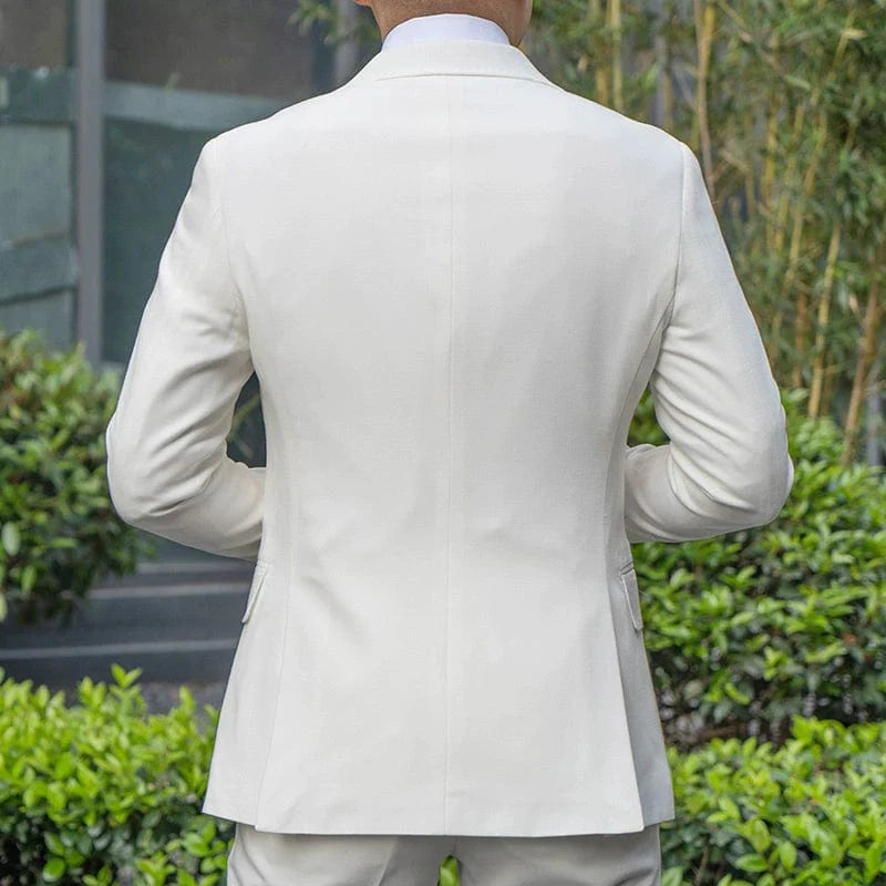 Showlu Fashion men's white two-piece slim fit tuxedo suit set, featuring a tailored jacket and matching trousers for formal occasions.